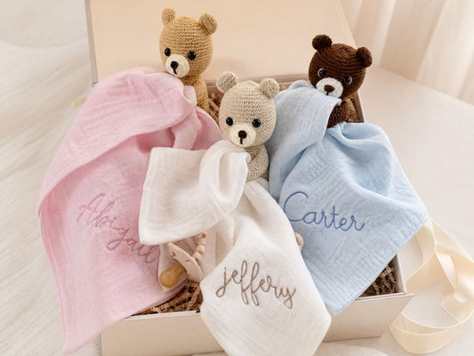 Close-up of handmade Beau Bear and embroidered muslin lovey detail