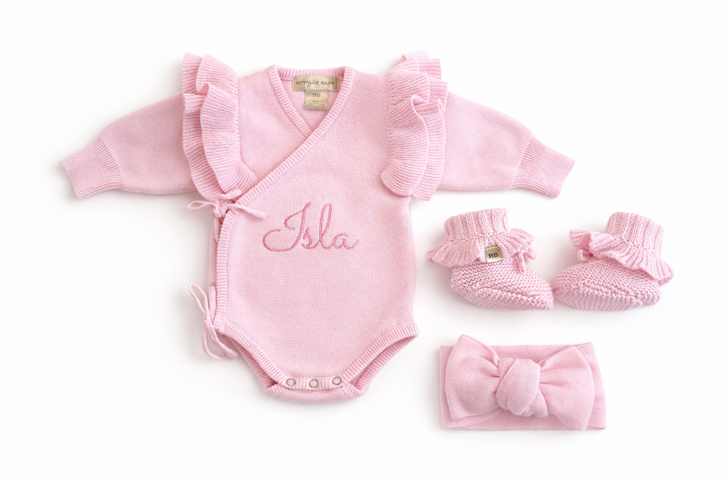 Three-piece personalized petal pink Butterfly romper set with matching bow and booties on white background