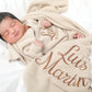 Newborn baby wrapped in personalized classic knit blanket with embroidered name in soft khaki cotton