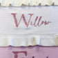 Personalized floral initial baby blanket with embroidered name and soft ruffled trim in knit cotton