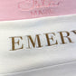Close-up of personalized baby blanket embroidery showing script and block name styles on knit fabric
