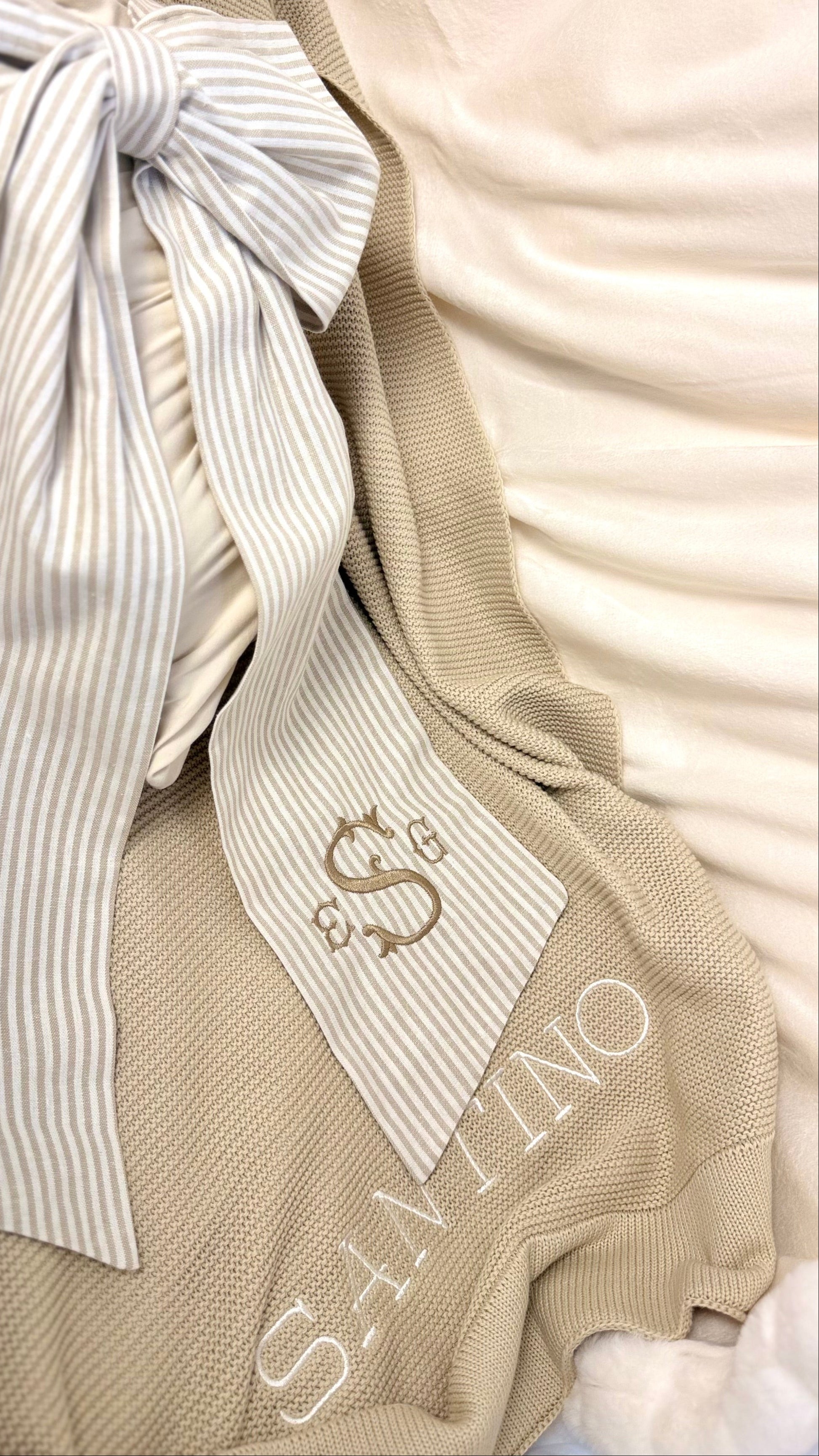 Personalized baby blanket with embroidered name styled with ribbon detail in soft khaki knit