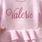 Personalized pink ballerina knit baby romper with embroidered name and ruffle detail, designed for newborn coming home outfit