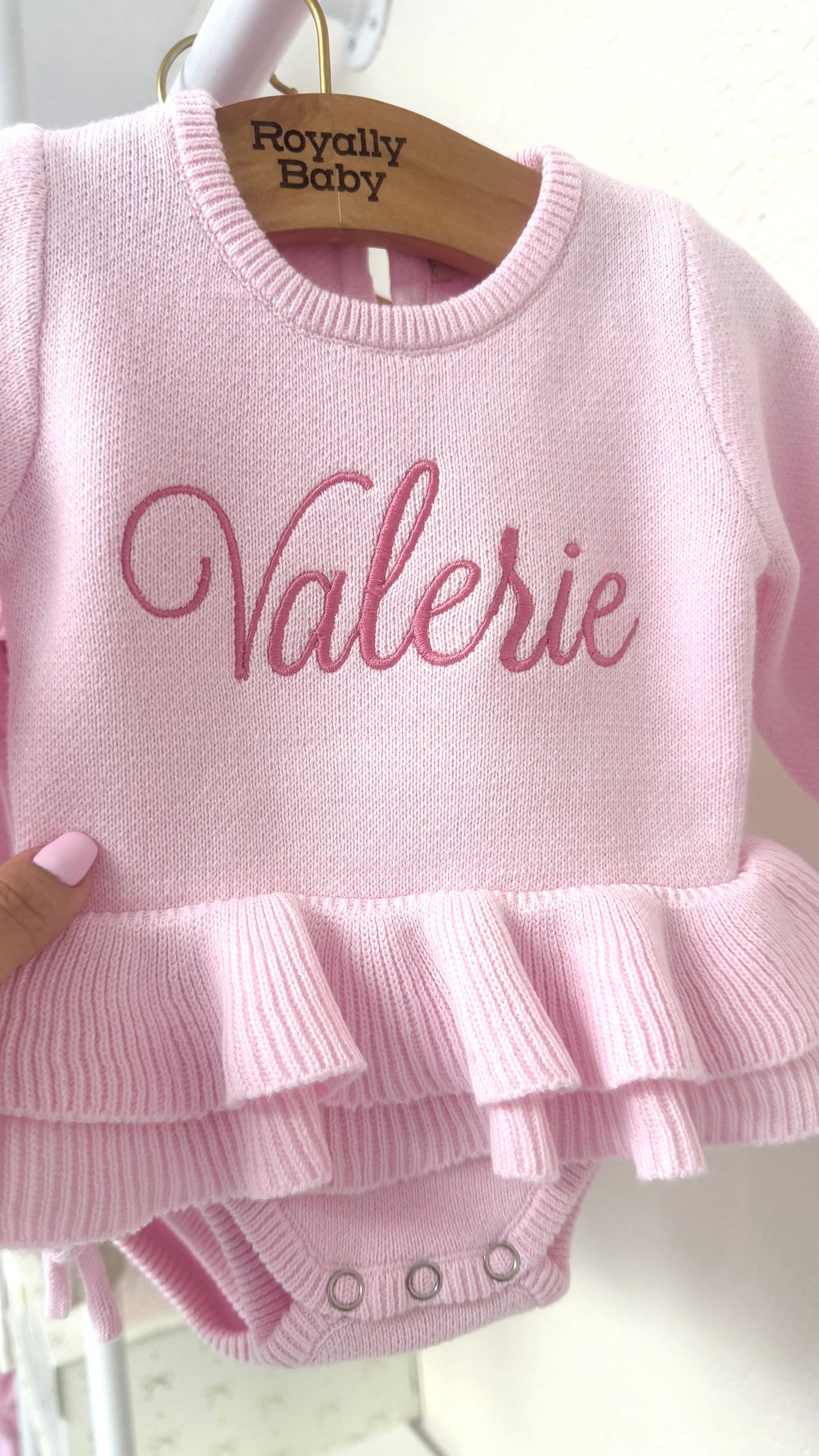 Personalized pink ballerina knit baby romper with embroidered name and ruffle detail, designed for newborn coming home outfit