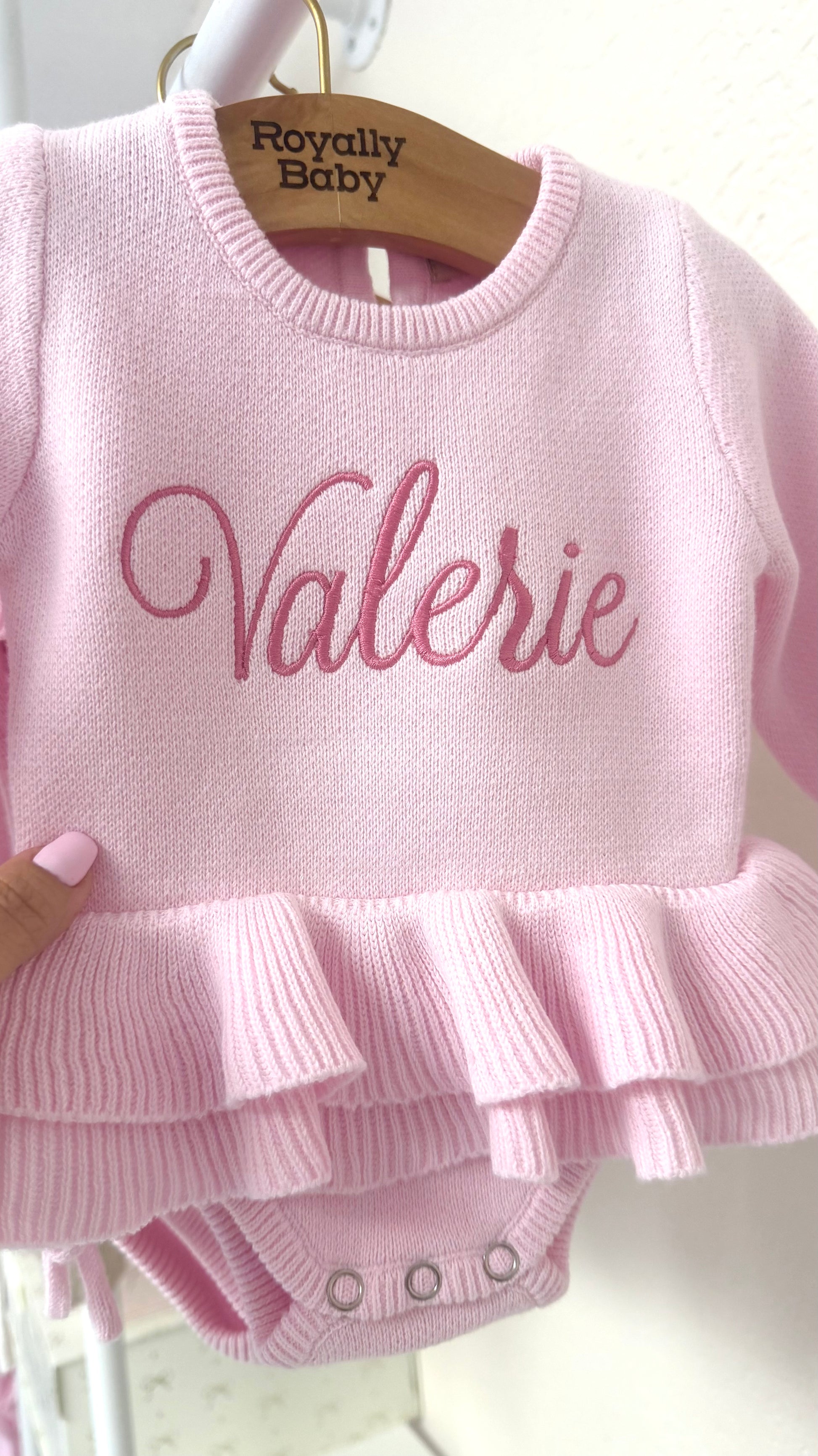 Personalized pink ballerina knit baby romper with embroidered name and ruffle detail, designed for newborn coming home outfit