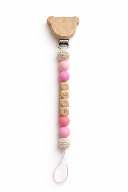 Personalized baby pacifier clip with Lola name beads in soft pink tones, a practical and meaningful newborn gift