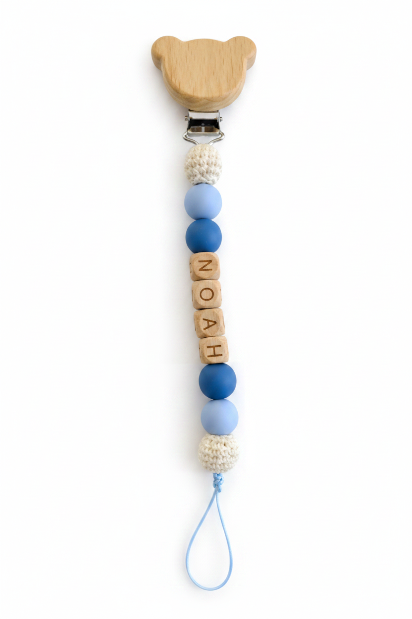 Personalized baby pacifier clip with Noah name beads in soft blue tones, a practical and thoughtful newborn gift