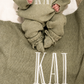 Newborn wearing a personalized Soft Sage Kimono Romper Set with matching bear-ear hat and blanket