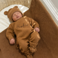 Personalized Teddy Brown newborn romper styled with the matching Classic Knit Blanket