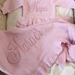 Petal pink Ballerina long romper set displayed with matching bow, ruffle booties and personalized ruffle blanket.