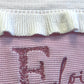 Video of personalized floral initial baby blanket with embroidered name and soft ruffled trim in knit cotton