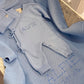 Baby Blue Classic Knit long romper set displayed with its matching newborn hat, booties and personalized knit blanket.