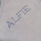 Close-up of Alfie name embroidery on the Baby Blue Classic Knit long newborn romper.