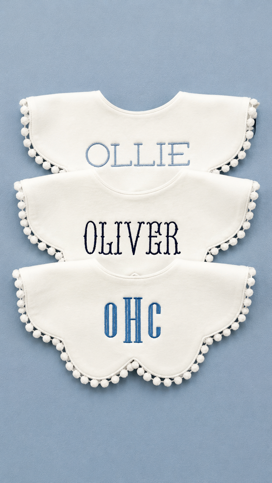 Baby boy bib trio styled flat lay showing all three designs