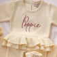 Poppie embroidery on the Buttercream Yellow Ballerina long romper with matching bow and ruffle booties