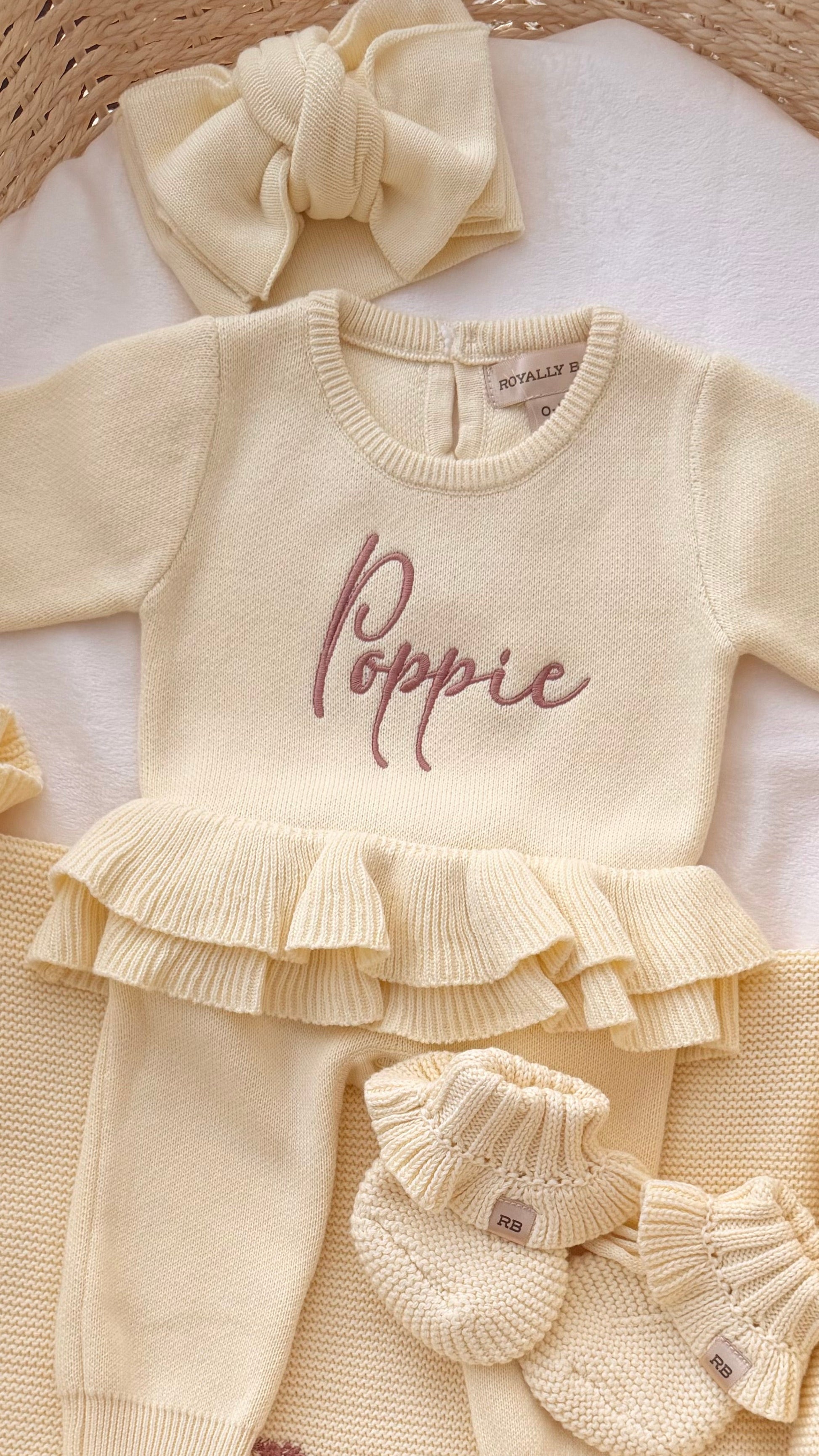 Poppie embroidery on the Buttercream Yellow Ballerina long romper with matching bow and ruffle booties