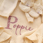 Personalized Buttercream Yellow ruffle knit blanket embroidered with Poppie, matching bow, and ruffle booties
