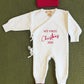 Close-up of My First Christmas embroidery in red thread on a newborn boy Christmas romper