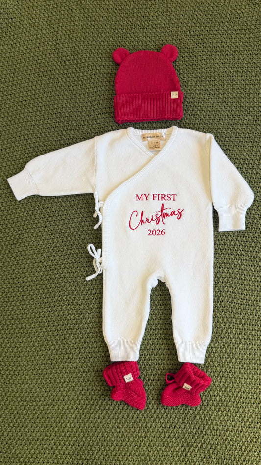 Close-up of My First Christmas embroidery in red thread on a newborn boy Christmas romper
