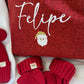 Personalized Christmas gift sack styled with holiday greenery and ornaments