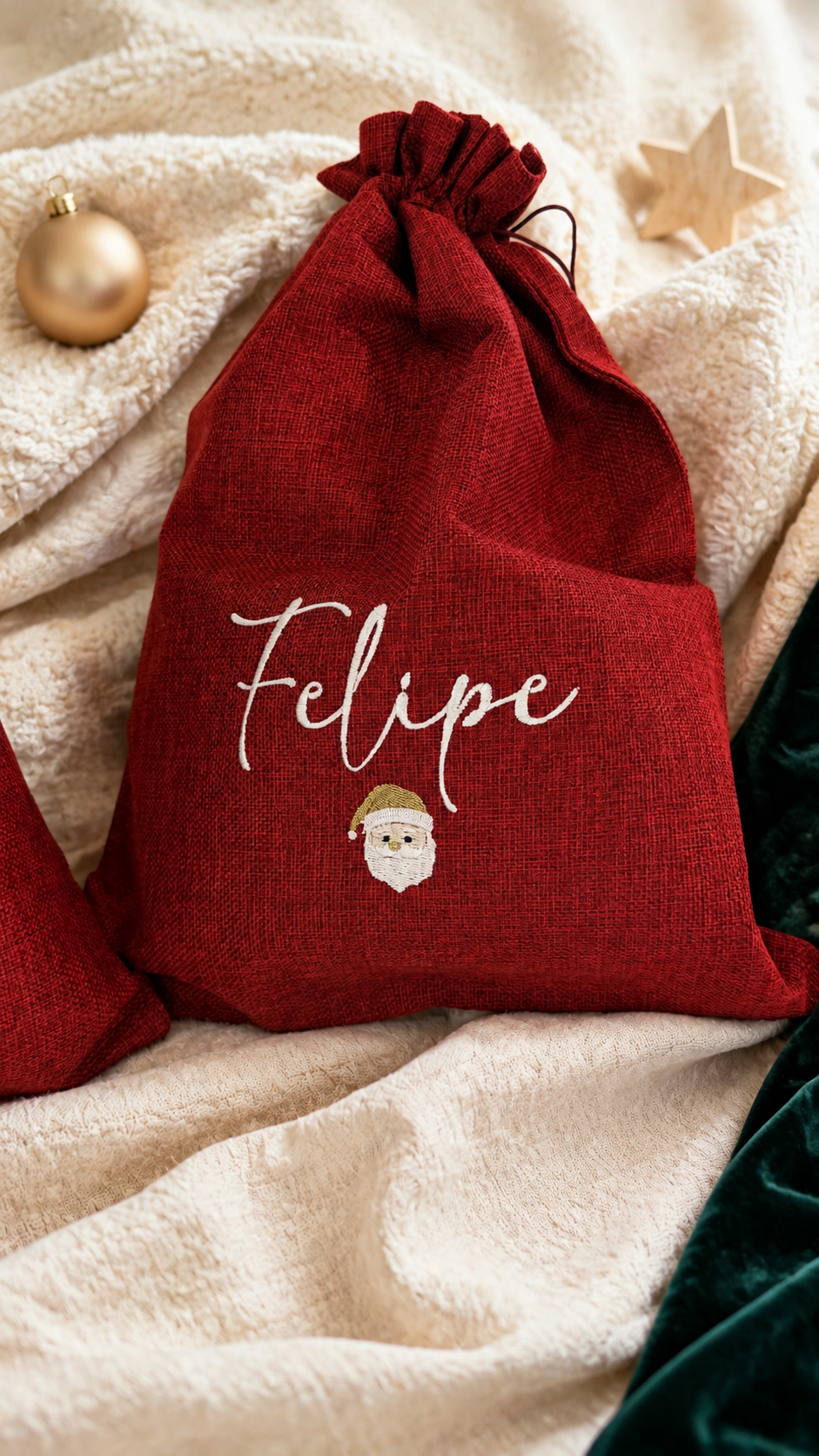 Personalized Santa Claus gift sacks styled on ivory bouclé with Christmas ornaments