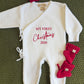 Newborn girl in a Warm White Kimono Christmas romper with matching bow and booties