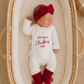 Close-up of My First Christmas embroidery on a newborn girl Christmas romper
