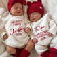 Twin newborns wearing personalized Christmas rompers embroidered with their names in English and Spanish