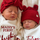 Sleeping newborns in red Christmas knitwear with personalized name embroidery