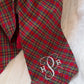 Close-up of monogram embroidery on a newborn Christmas sash