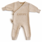 Classic knit wrap romper in soft khaki with personalized embroidery, front view on white background