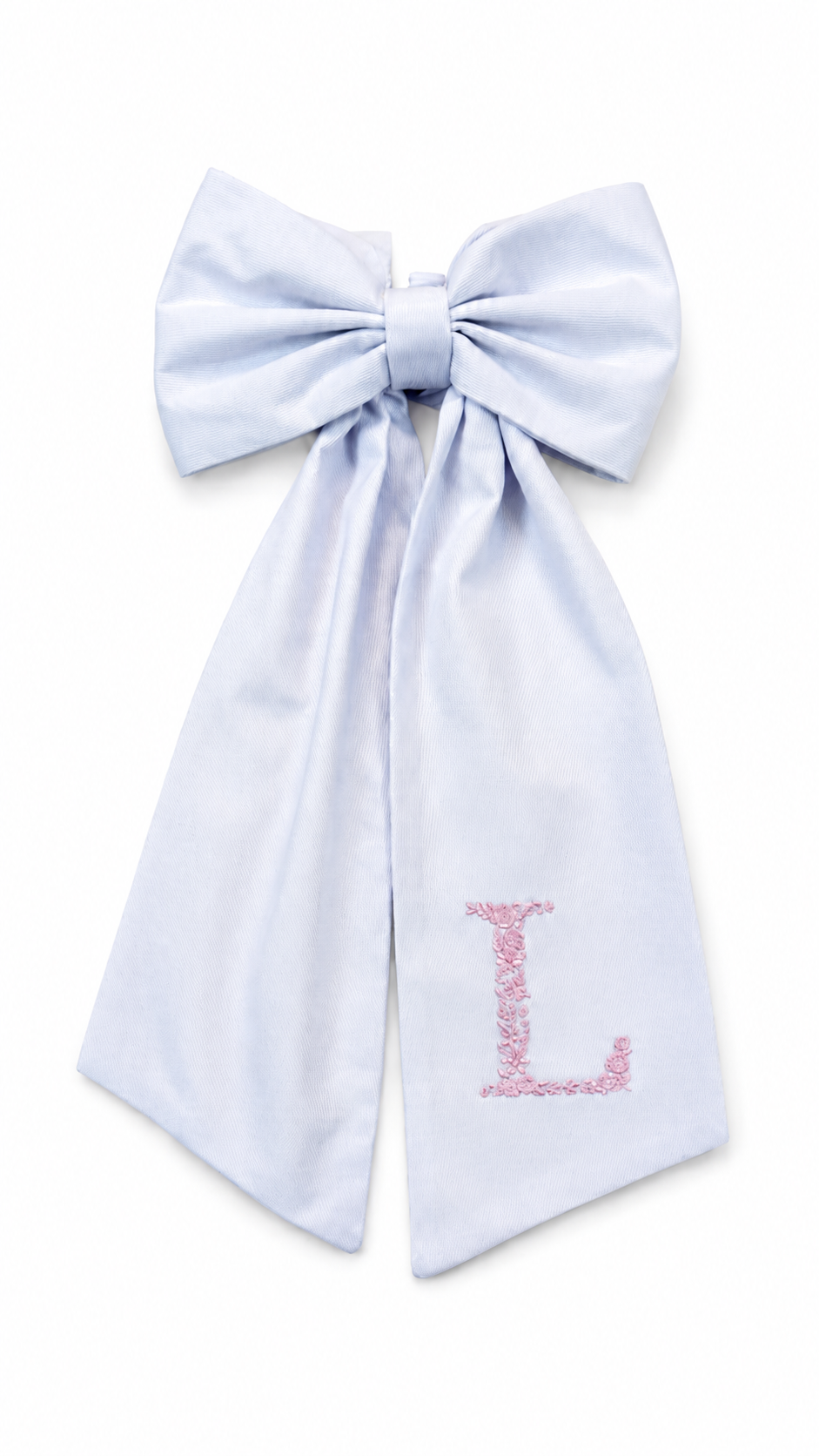 Close-up of floral initial embroidery on a personalized newborn bow sash