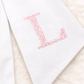 Floral Initial bow sash flat lay showing embroidery design and pre-made bow