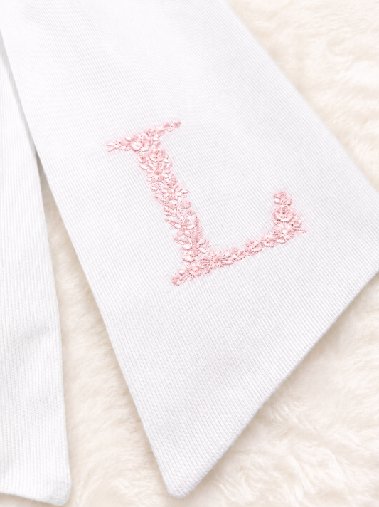 Floral Initial bow sash flat lay showing embroidery design and pre-made bow
