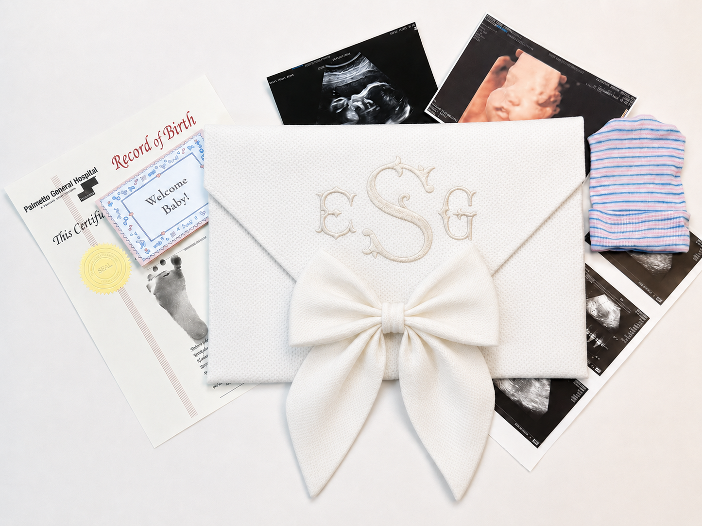 First Moments Keepsake Envelope shown open with hospital bracelet and first photo