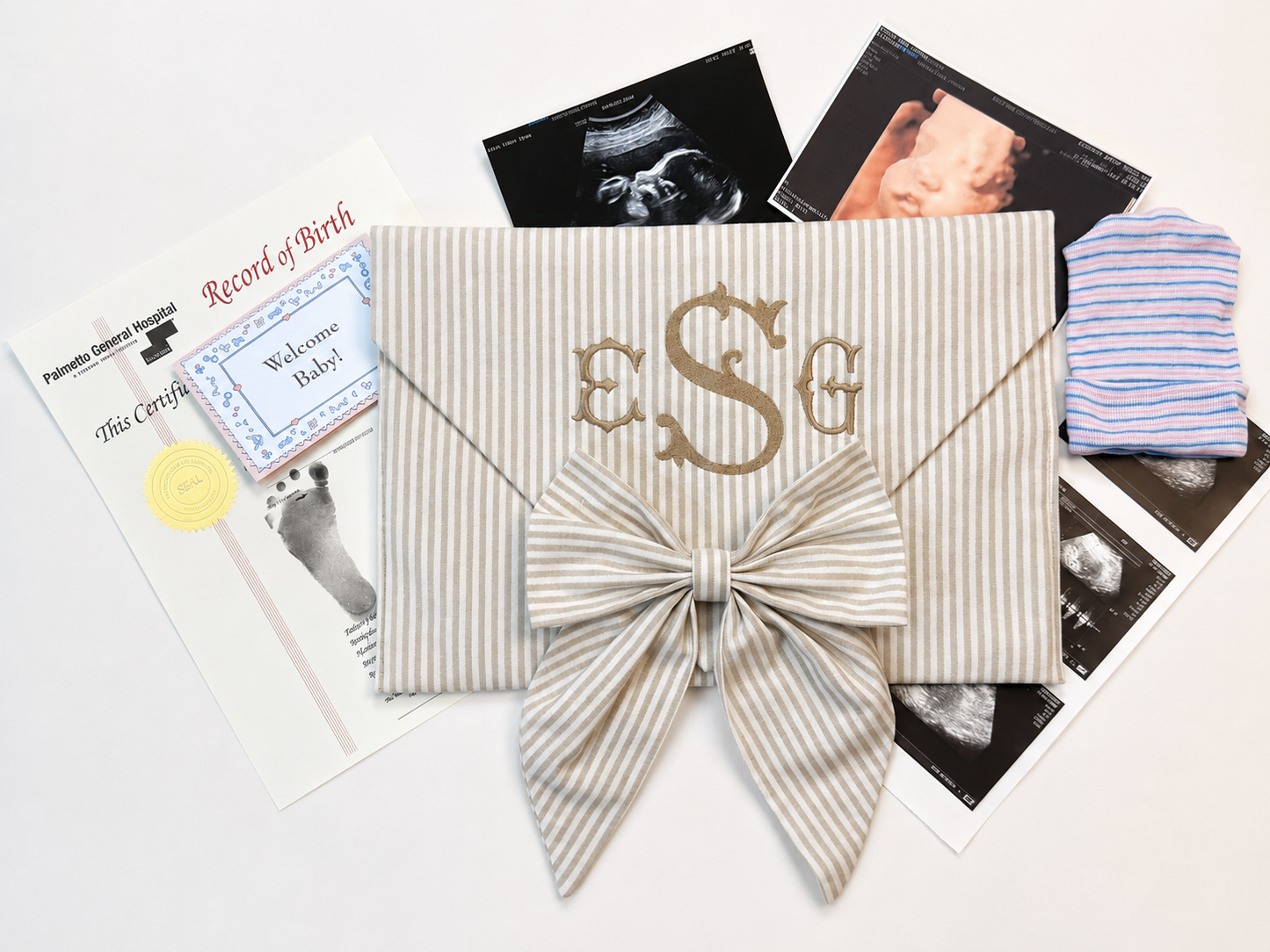 First Moments Keepsake Envelope styled with hospital bracelet and ultrasound photo