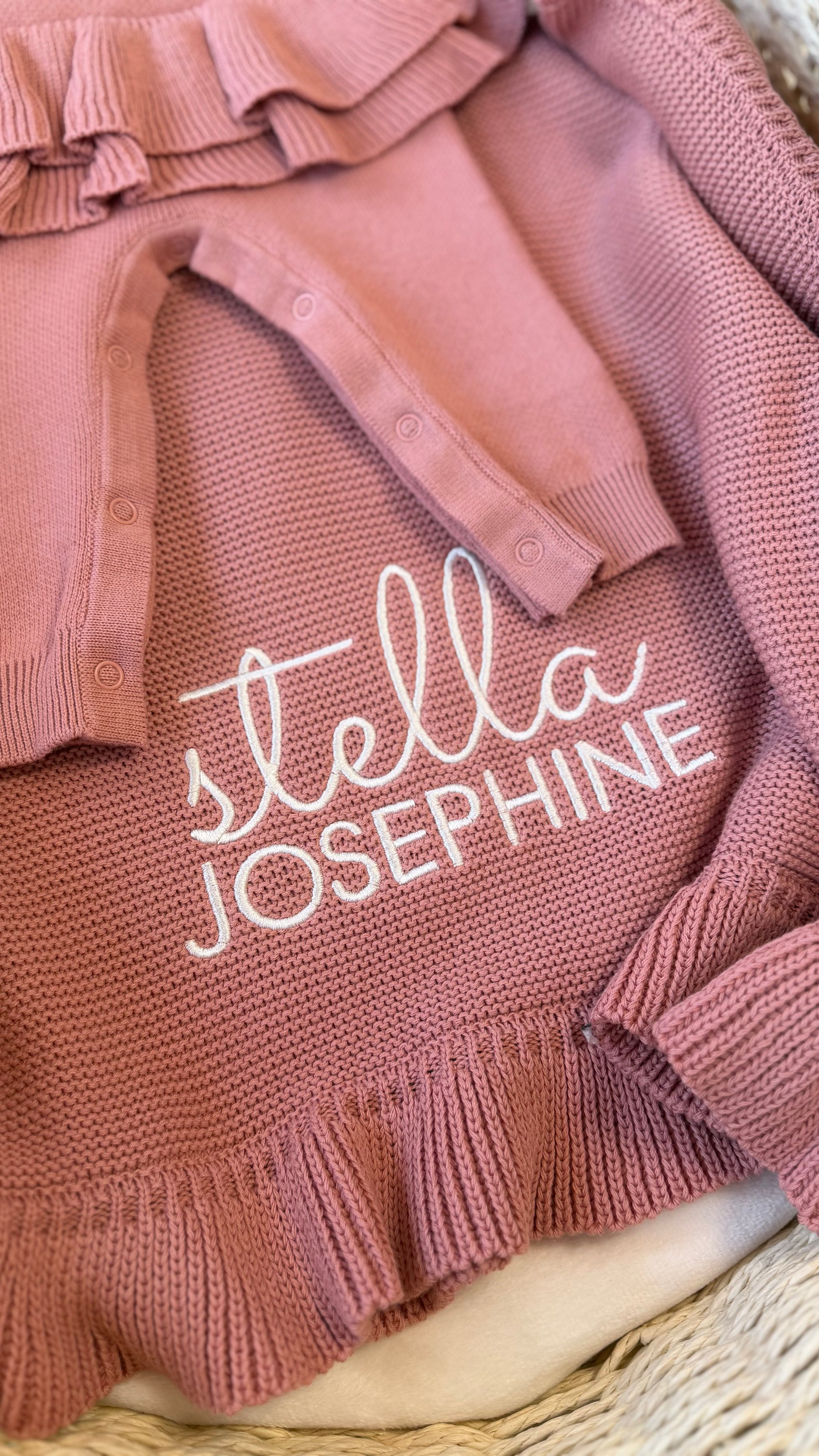 Close-up of Stella Josephine name embroidery on the personalized Mauve ruffle knit newborn blanket.