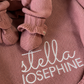 Mauve ruffle newborn booties displayed on the personalized knit blanket embroidered with Stella Josephine.