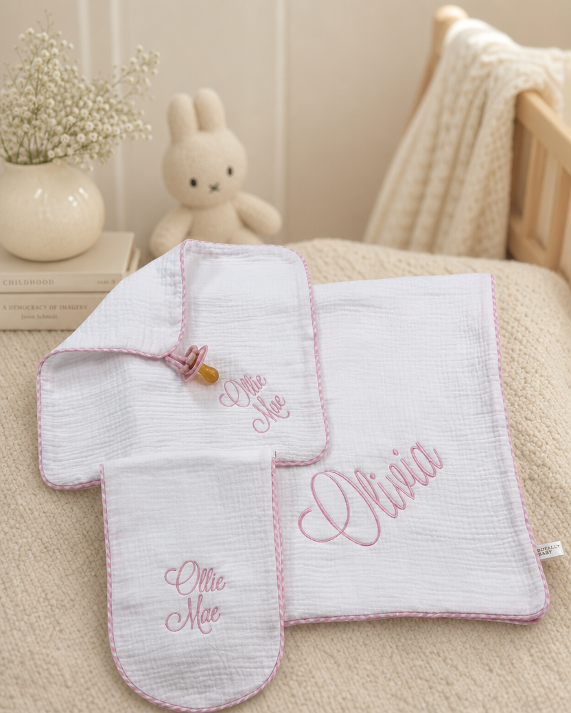 Embroidered muslin pacifier lovey detail from 3-piece pink gingham set