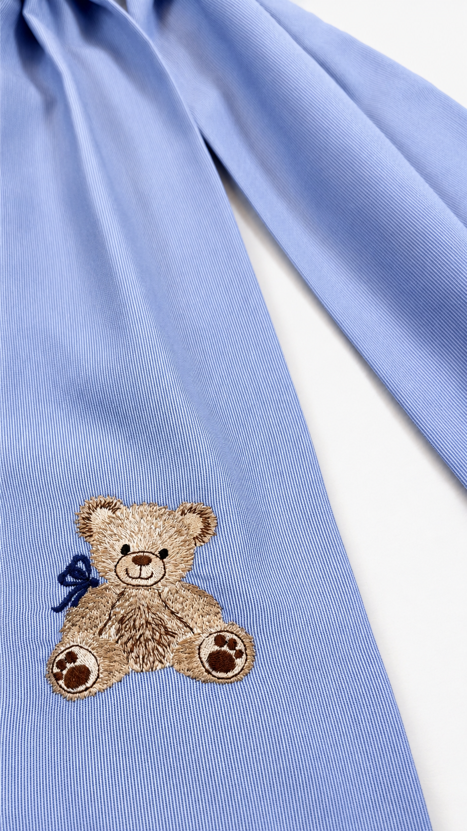 Close-up of Nursery Classics embroidery and monogram on a personalized newborn bow sash