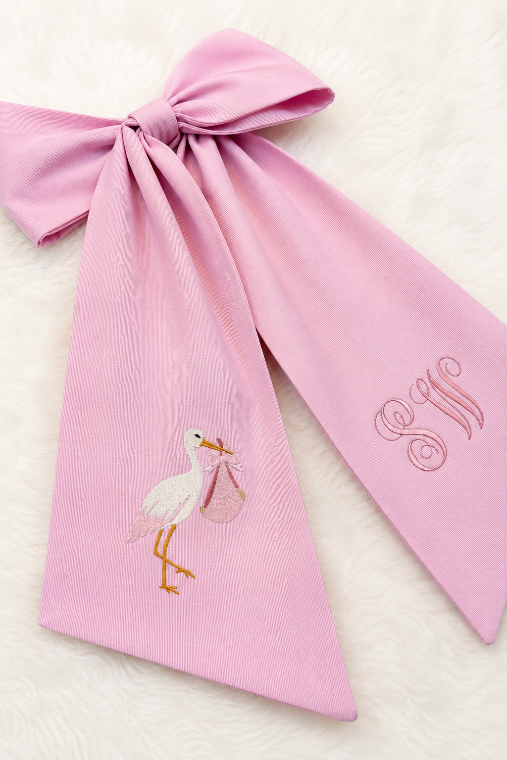 Newborn wearing the Nursery Classics bow sash with pre-made bow, styled for hospital photos