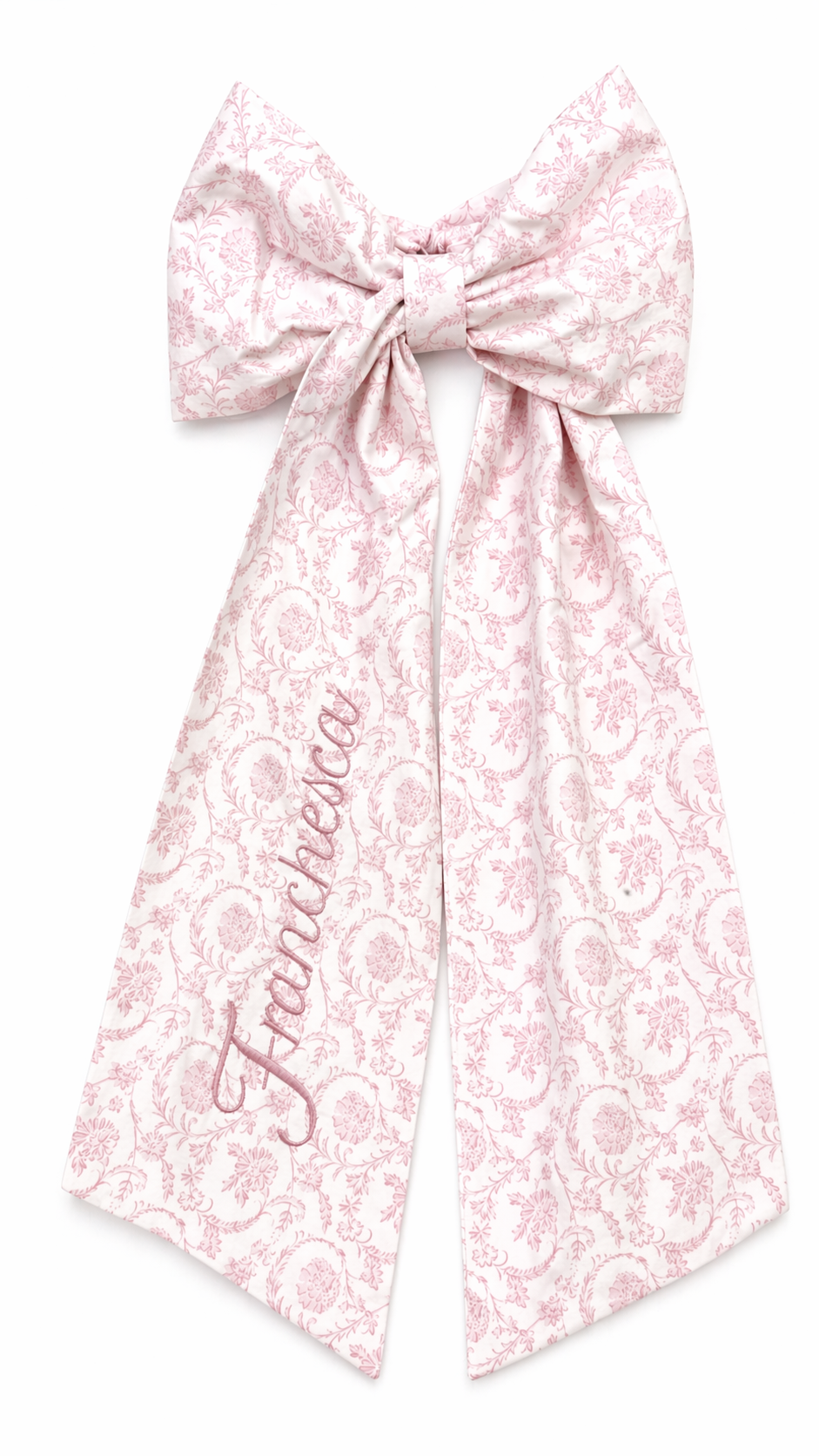 Personalized pink floral newborn name sash bow with embroidered script name detail for baby girl hospital announcement photos and luxury coming home styling.