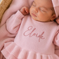 Close-up of embroidered name on personalized petal pink Ballerina romper for newborn girls
