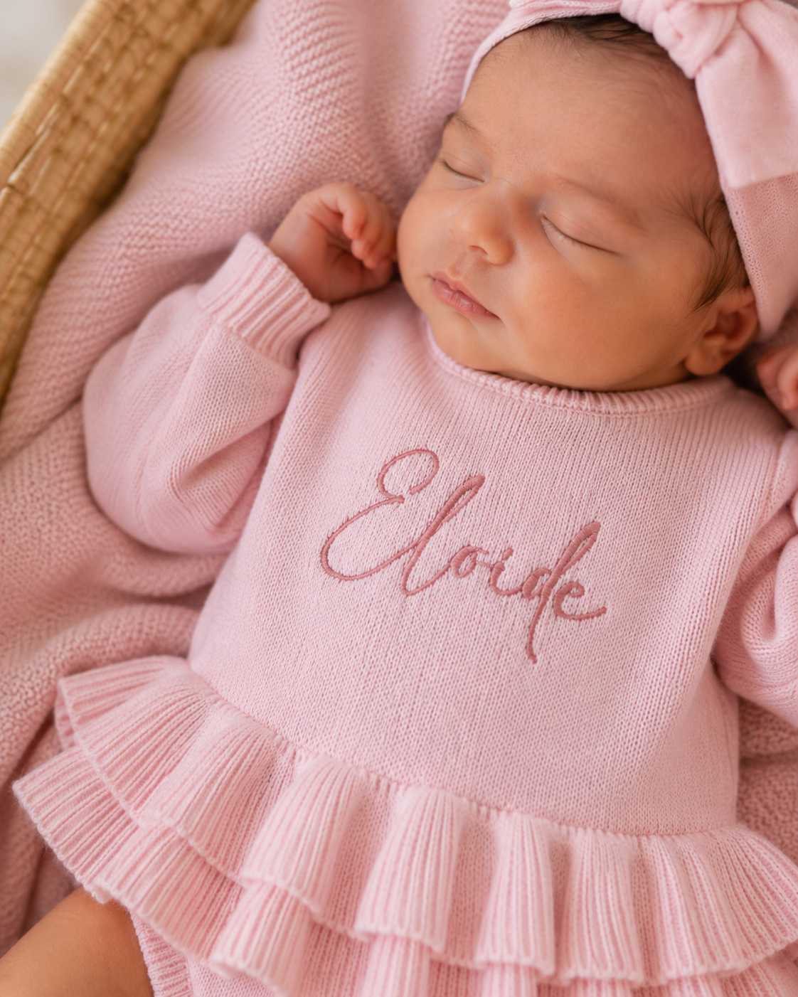 Close-up of embroidered name on personalized petal pink Ballerina romper for newborn girls
