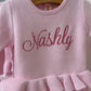 Detail view of personalized petal pink Ballerina romper for newborn coming home outfit