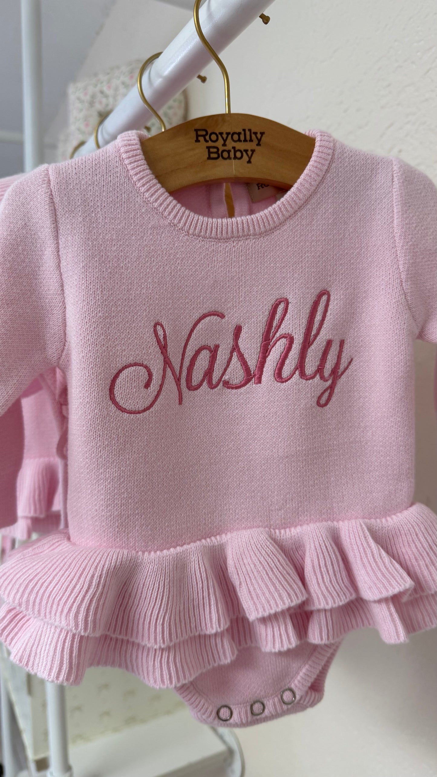 Detail view of personalized petal pink Ballerina romper for newborn coming home outfit