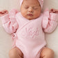 Detail view of personalized petal pink Butterfly romper for newborn coming home outfit