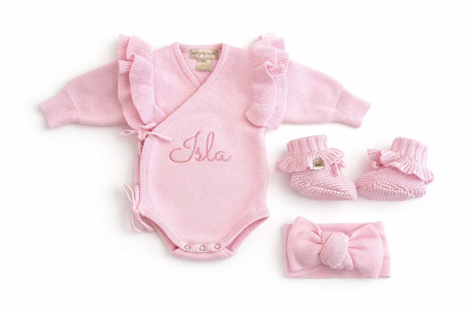 Three-piece personalized petal pink Butterfly romper set with matching bow and booties on white background