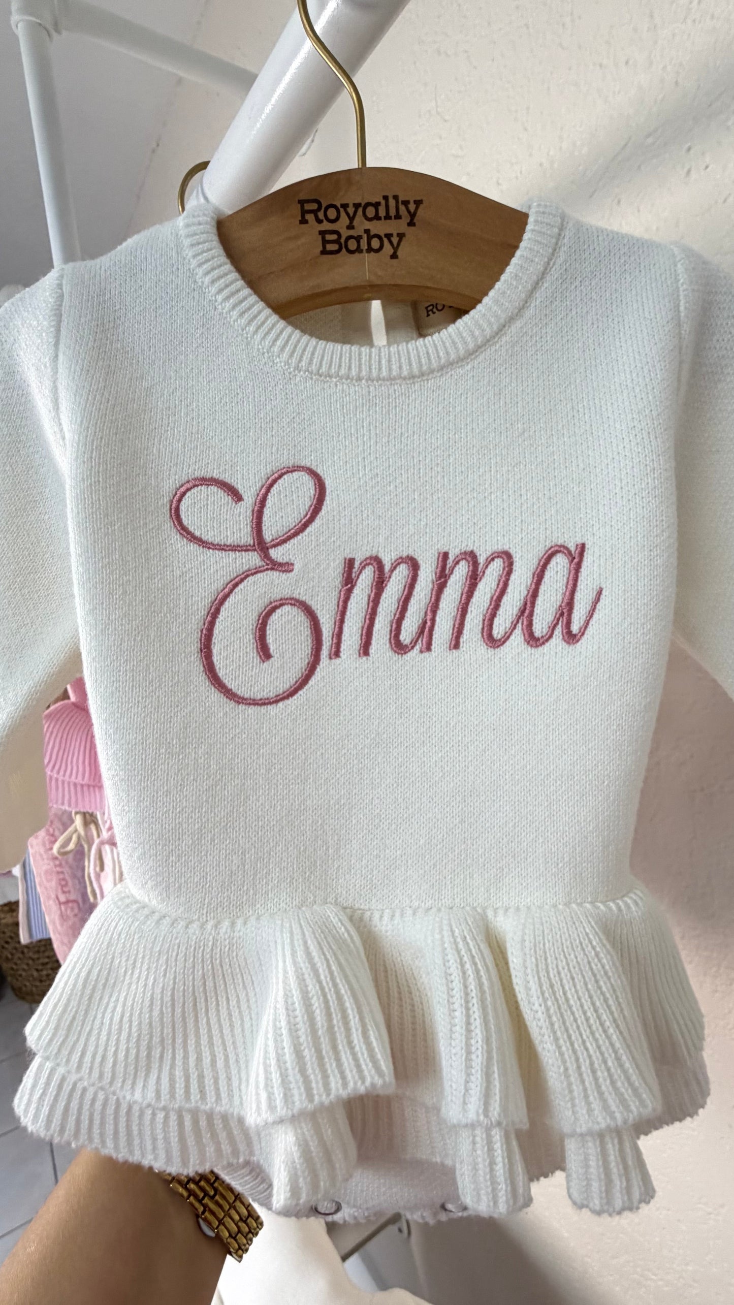 Newborn wearing personalized Warm White Ballerina romper, styled angle