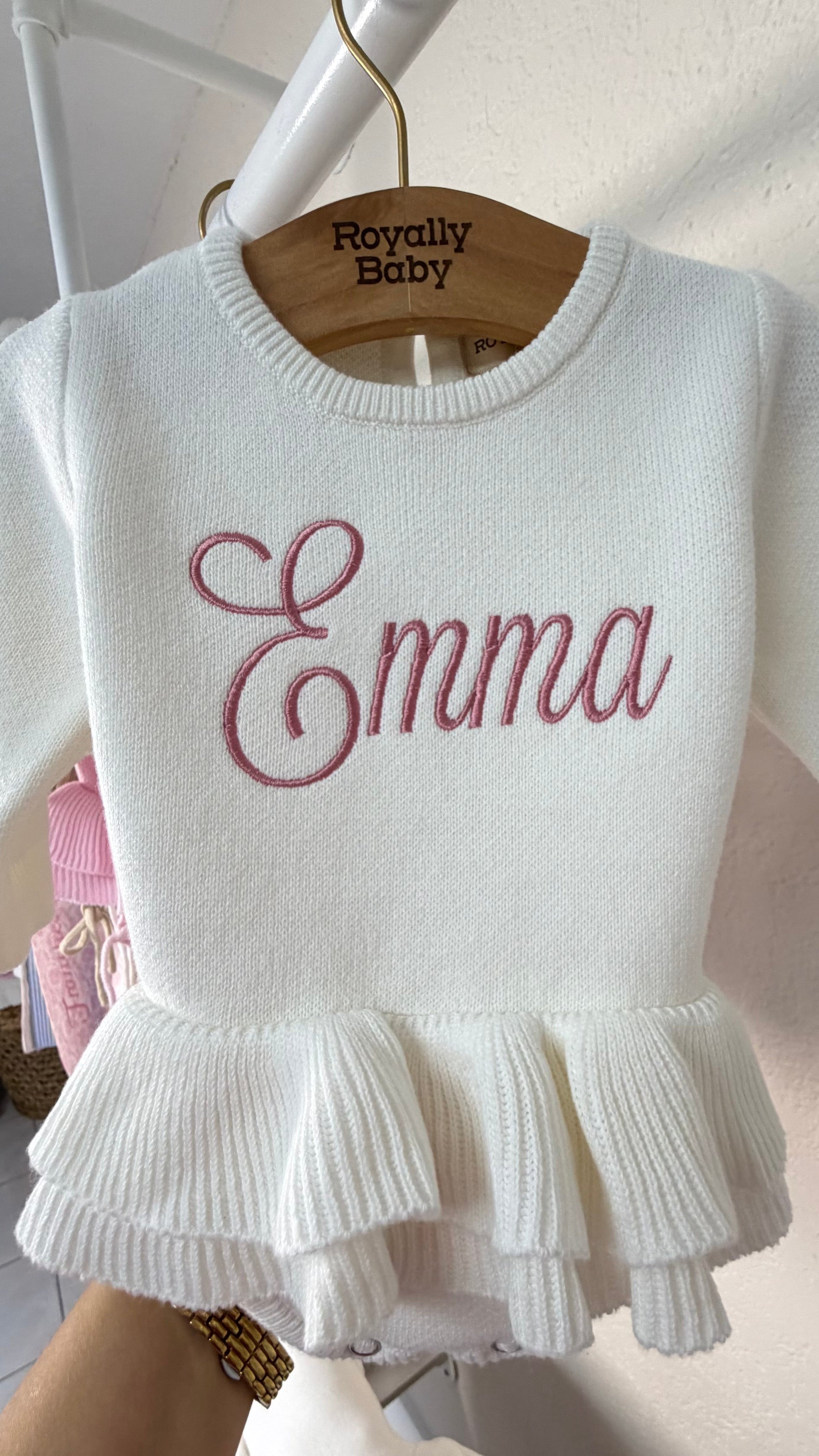 Newborn wearing personalized Warm White Ballerina romper, styled angle